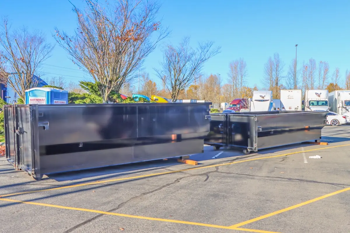 Professional dumpster rental service with roll-off container on residential driveway in Morton